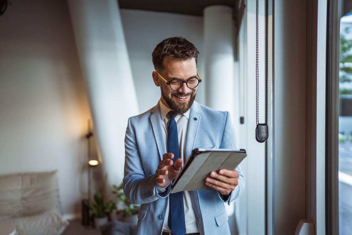 Lawyer in suit looking at a tablet in office